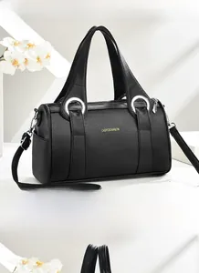 Detail of black pebbled leather Boston bag with silver metal rings and adjustable strap