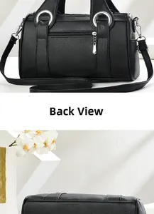 Detail view of the black pebbled leather bag back zip pocket and flat textured bottom