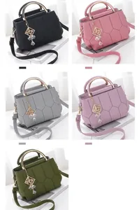 Close-up of quilted leather handbags in black, pink, grey, purple and green colors