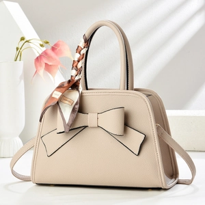 Beige lychee leather handbag with 3D bow and floral silk scarf wrapped around handle