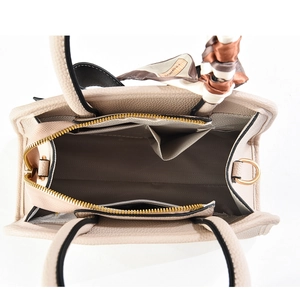 Interior view of beige litchi grain handbag showing large capacity and silk scarf detail