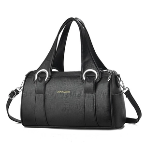 Chic black pebbled leather pillow handbag with silver rings and detachable shoulder strap