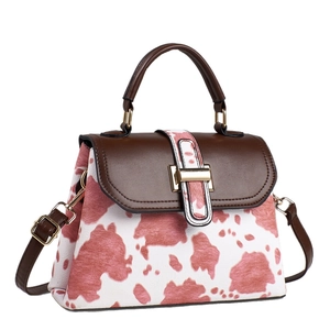 Pink cow print crossbody bag with brown leather trim and golden metal clasp for women