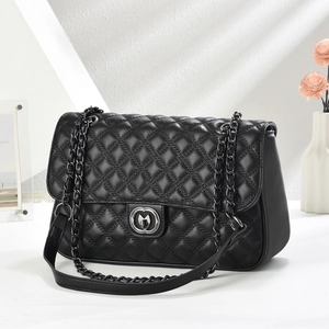 Quilted black leather chain bag featuring a heart-shaped rotating metal lock closure