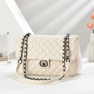 Quilted beige shoulder bag with diamond stitching and black metal chain strap