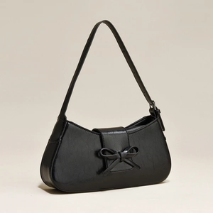 Elegant black underarm bag with bow detail and vintage cracked leather texture