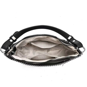 Interior detail of black leather tote with spacious compartments and zigzag fabric lining