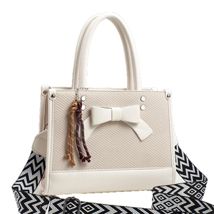 Sac à main en toile beige chic avec nœud en cuir et bandoulière à motifs géométriques
