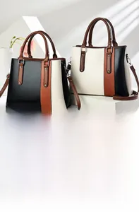 Detail view of contrast color tote bag with metal rivets and bottom protective feet