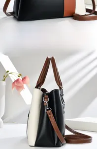 Detailed view of tri-color patchwork leather handbag with handles and shoulder strap