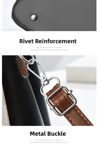 Detail view of reinforced rivets and silver metal hardware on a two-tone leather handbag
