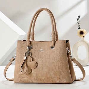 Chic khaki crocodile leather handbag with floral charm and adjustable strap