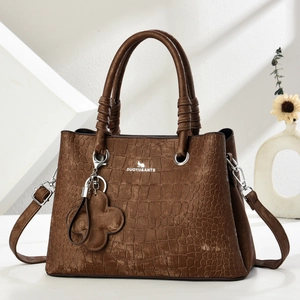 Dark brown faux crocodile skin handbag with shoulder strap and flower charm accessory
