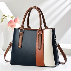 Schicke Leder-Handtasche in Marineblau, Braun und Creme mit verstellbarem Riemen