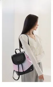 Detail view of mini backpack with blue-pink gradient, floral pattern and leather straps