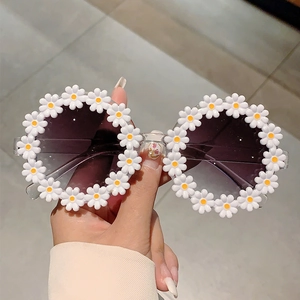 Close-up of cute daisy flower frames on round sunglasses with gradient lenses