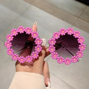 Detail of purple daisy flower shaped frame for kids sunglasses with grey lenses