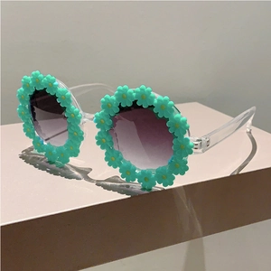 Detail of cute flower daisy sunglasses for kids with mint green petals and purple lenses
