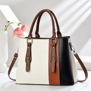 Three-color patchwork leather handbag for women featuring top handles and silver hardware