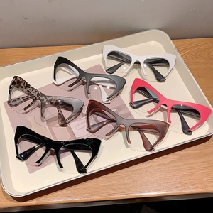 Assorted colors of retro cat-eye half-frame glasses displayed on a tray for styling