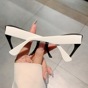 Macro view of deconstructed X-shaped cat eye frames with black and white contrast