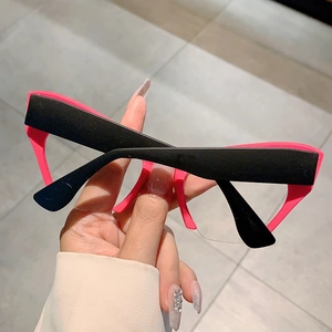 Detail view of bold cat eye frame with contrasting black and neon pink design