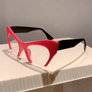 Detail of trendy rose pink and black cat-eye frames with clear anti-blue light lenses