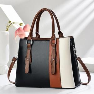 Elegant tri-color patchwork handbag with top handles and adjustable shoulder strap