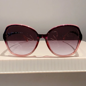 Detailed front view of women's butterfly sunglasses with purple gradient frame and lenses