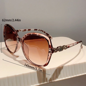 Detail view of large tortoise sunglasses with gold chain accents and size dimensions