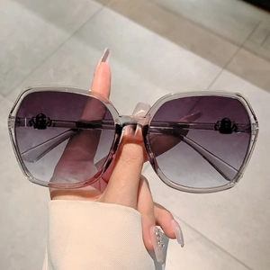 Macro detail of oversized gradient purple lenses with insect-shaped metal accents