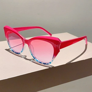 Detail of cat-eye sunglasses featuring pink floral gradient frames and tinted lenses