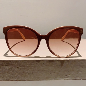Close-up of vintage cat-eye sunglasses with gradient lenses and brown resin frames