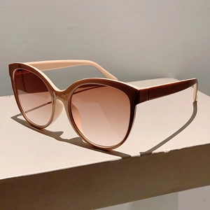 Detail of cat eye sunglasses showing brown tortoiseshell frames and two-tone temples