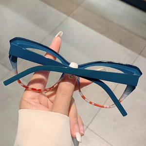 Close-up of cat-eye frames featuring blue top and floral tortoiseshell lower rim