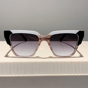 Close-up of square gradient lens sunglasses with white and brown striped frames