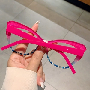 Detail of cat eye glasses frame with vibrant rose red and blue striped pattern design