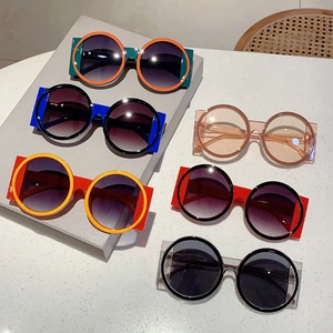 Collection of retro round oversized sunglasses with colorful contrast frames on display