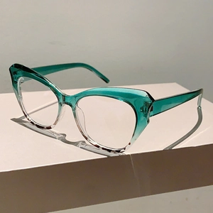 Detail of cat-eye glasses frame featuring teal gradient and tortoiseshell texture
