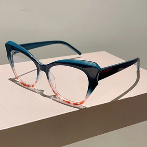 Detail of cat-eye frames with teal gradient and orange tortoise shell pattern accents