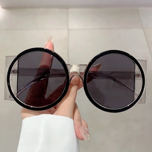 Retro oversized round sunglasses with black frames and transparent square side wings