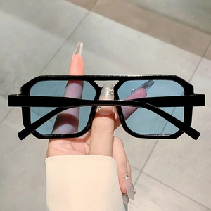 Detail of square black frame sunglasses with light blue lenses and chunky temple design