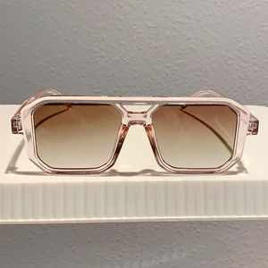 Front view of square pink sunglasses with gradient brown lenses and double bridge detail