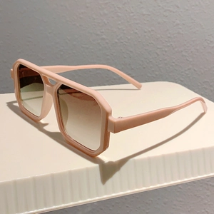 Detail of pink double-bridge square sunglasses featuring gradient lenses and retro thick frames