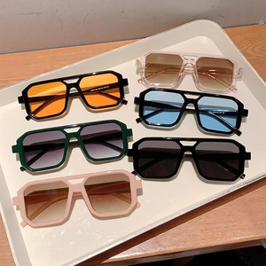 Classic double-bridge square sunglasses in multiple lens colors on white tray