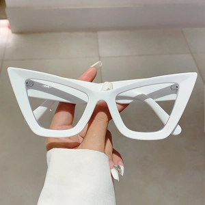 Close-up of white cat-eye glasses frames with a bold triangular silhouette and wide temples