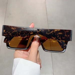 Macro detail of tortoiseshell square oversized sunglasses with vintage amber tinted lenses