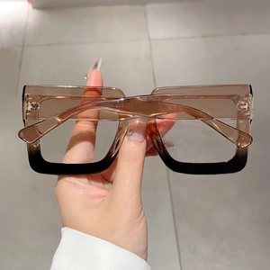 Detailed close-up of large square gradient frame glasses with retro fashion style