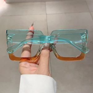 Detail view of square gradient glasses frames with teal and amber resin colors