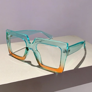 Detail of square oversized glasses frame with blue and amber gradient texture